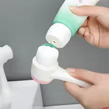 Silicone facial cleansing brush with soft bristles being prepared with cleanser for deep pore cleaning and skincare routine